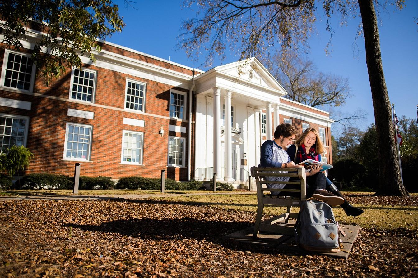 Student reading on bench at Newnan